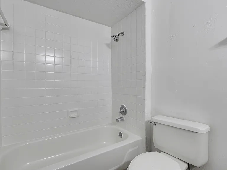 Bathroom with tiled tub and shower surround