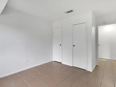 Bedroom with two closets and tiled floor