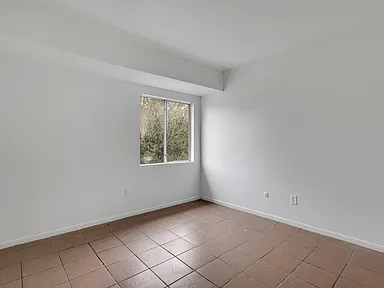 Bright bedroom with tiled floor and exterior window